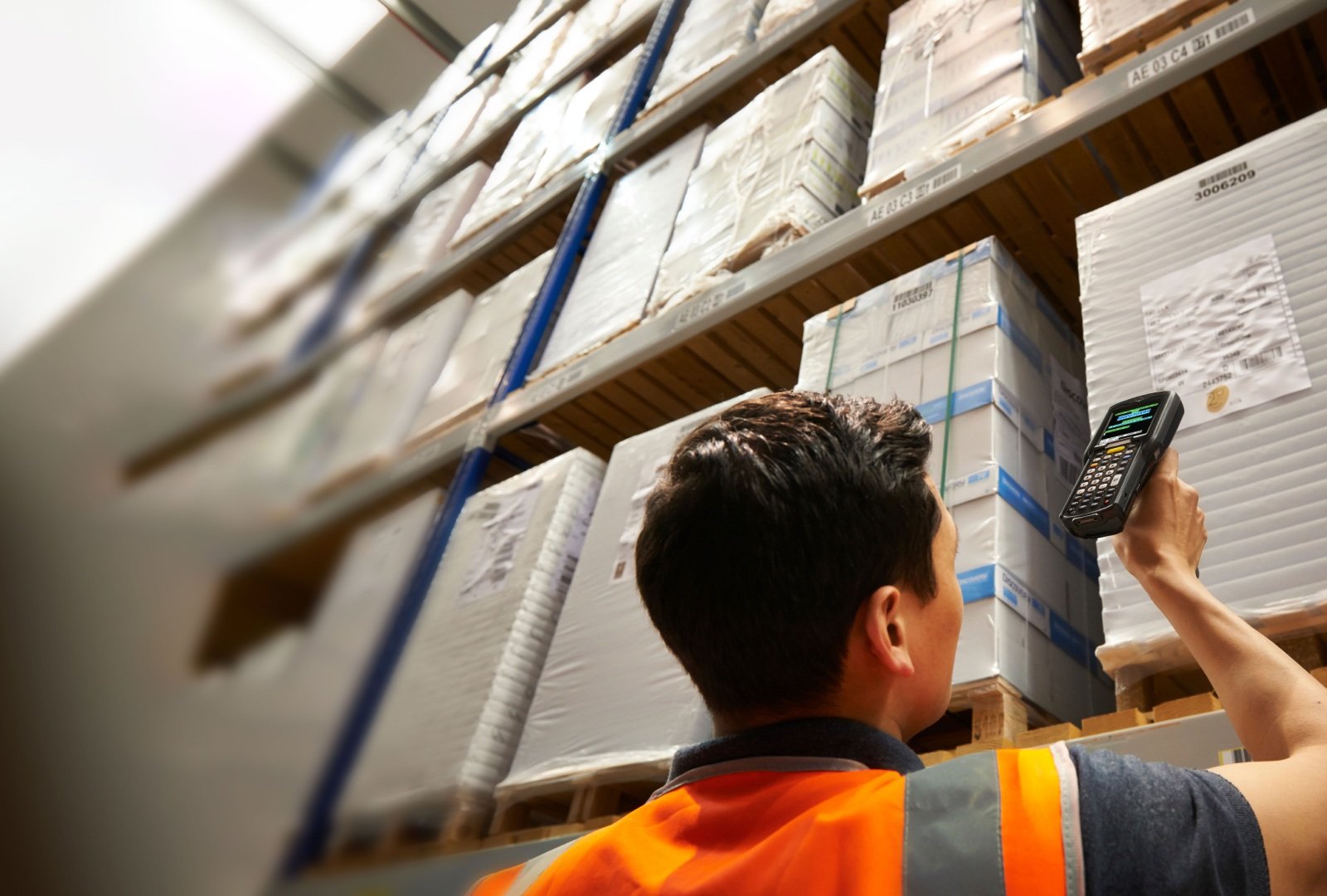 Man in a reflective vest using a remote scanning device.