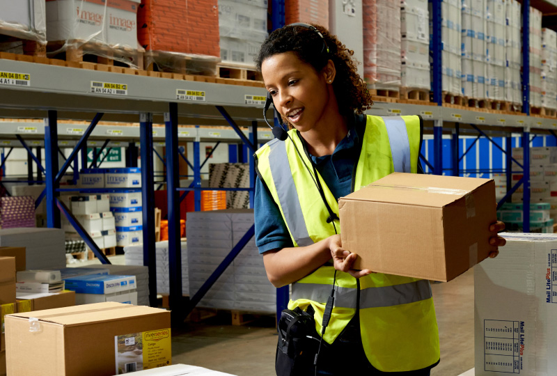 woman wearing a headset picking items